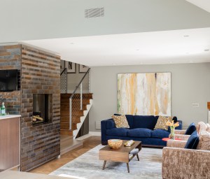After: Living room view toward stairs-the open concept floor plan showcases a collection of contemporary art.