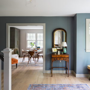 Off the front entry the old dining room was transformed to a bright, stylish home office. The new office features a double window created by reusing an old window next to an existing window, significantly brightening the space. 