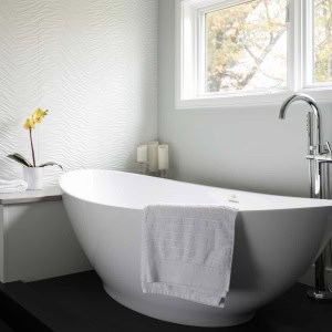 ANDOVER TOWNHOUSE BATH-The wave theme is repeated with the wave white porcelanosa tile wall alongside the tub. An elevated tub deck doubles as a drying platform outside of shower. The innovative Link floor tile features a vinyl top above a pvc base which prevents water absorption. 2017 Designer Bath Shine award for best spa bath.