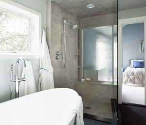 ANDOVER TOWNHOUSE MASTER BATH-The wavevue glass in the shower window and pocket door create a transparent and architecturally interesting connection between the bath and master bedroom, while still allowing for privacy. 2017 Designer Bath Shine award for best spa bath.