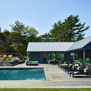 View of built-in hottub. Poolhouse is lined with sliding glass doors to accommodate a constant flow of guests, who can shelter on the covered patio or relax poolside in a chaise.