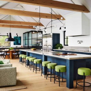 Wood beams anchor the kitchen’s pitched ceiling. A 22' custom made kitchen island services the owners' extended family and friends.