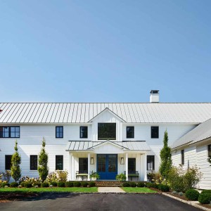 The home's science does not diminish its aesthetics.  With its prim white siding, metal roof, and cozy front porch, the farmhouse presents a warm and welcoming face.