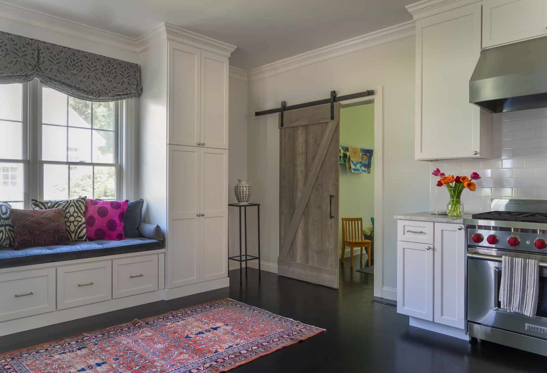 Rolling barn door separates playroom from kitchen
