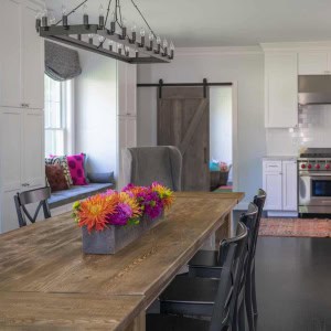 Farm style dining table coordinates with the rolling barn door