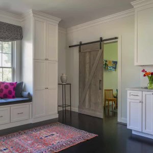 Rolling barn door separates playroom from kitchen