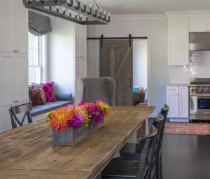 Farm style dining table coordinates with the rolling barn door