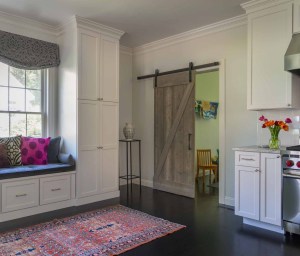 Rolling barn door separates playroom from kitchen