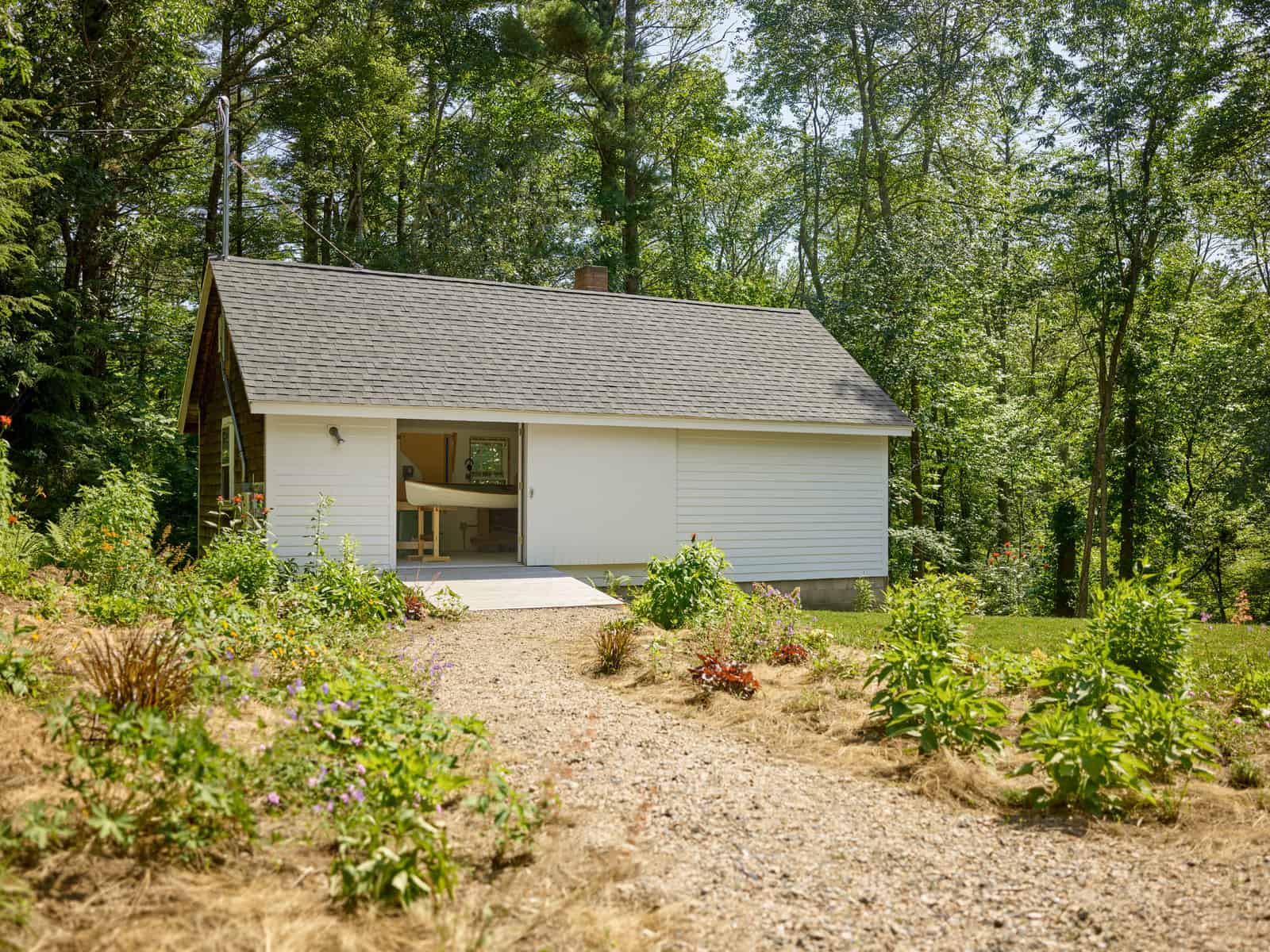 The original cottage was re-purposed into a furniture studio for the homeowner, a cabinetmaker, who built all the kitchen cabinetry, as well as some of the home’s furniture.