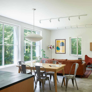 6’ x 6’ triple-pane windows, the most thermally efficient available today, were imported from Germany, inviting the sun to warm the concrete slab foundation that helps to moderate temperatures in the house by acting as a heat sink. Additionally, the windows provide “natural wall art”, offering expansive views along a brook.