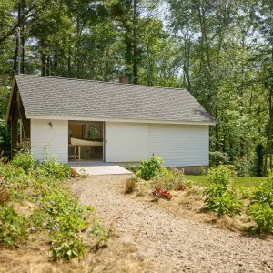 The original cottage was re-purposed into a furniture studio for the homeowner, a cabinetmaker, who built all the kitchen cabinetry, as well as some of the home’s furniture.