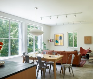 6’ x 6’ triple-pane windows, the most thermally efficient available today, were imported from Germany, inviting the sun to warm the concrete slab foundation that helps to moderate temperatures in the house by acting as a heat sink. Additionally, the windows provide “natural wall art”, offering expansive views along a brook.