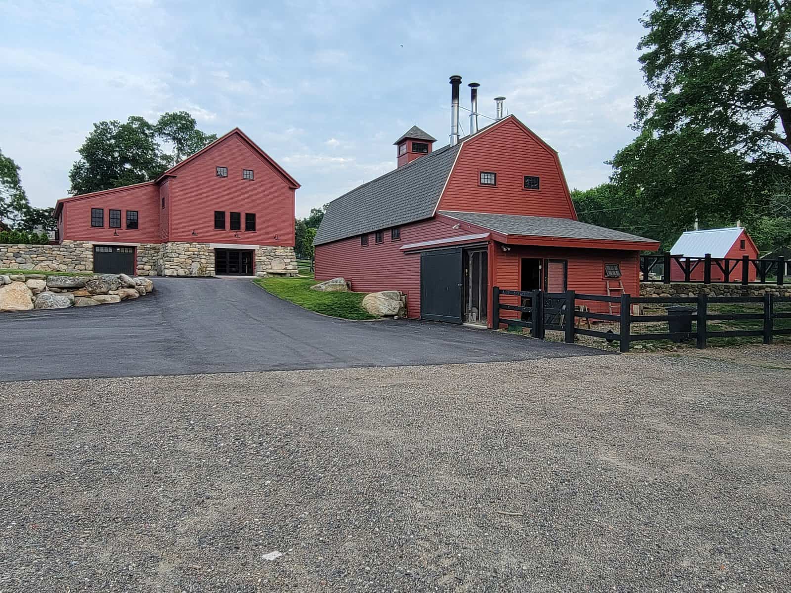 The bull barn was located in front of the 1793 barn. The bull stalls were removed and the building was converted to a maple sugaring facility. A traditional color palette was used to paint the buildings and fences to maintain the historical ambiance of the property.