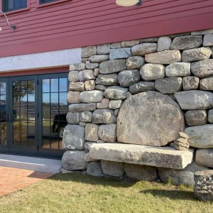 1793-Barn-Exterior Rear features a built in stone bench with stones sourced from property. Stonework by Eric Peterson Landscaping.
