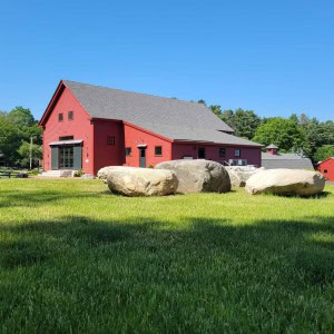 The project entailed: 1) partially restoring and renovating two barns that originated in 1793 and 1806;  2) converting an old bull barn into a maple sugaring barn; 3) constructing a new barn to house machinery; and 4) offsetting electricity with a field of solar panels, making the property net-zero.