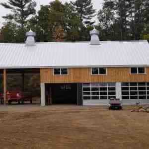 ibarn Front Elevation with tall hay wagon storage bays and three garage bays
