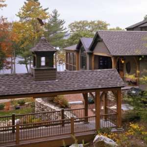 Maine Lakes Region Custom Home Covered Bridge to Garage