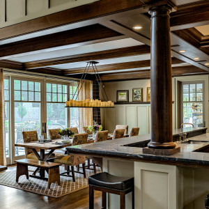 View toward dining with large picture window overlooking yard. A door to the three-season room offers easy access to an outdoor kitchen and living area.