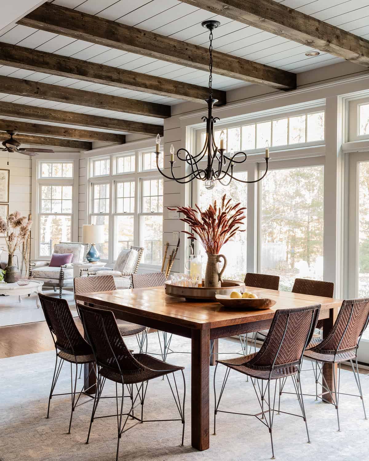 AFTER Breakfast Area- A wall was removed to connect breakfast to sunroom, two sets of French glass sliding doors now lead to pool. New space features floor to ceiling shiplap paneling and rustic wood beams.