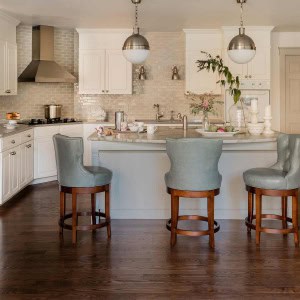 AFTER Kitchen was updated, though not fully remodeled. Cabinetry was extended to ceiling, new exhaust hood, counters, and grey/green subway tile. Flooring was replaced with an ash floor stained dark. Furniture style island anchors the room.