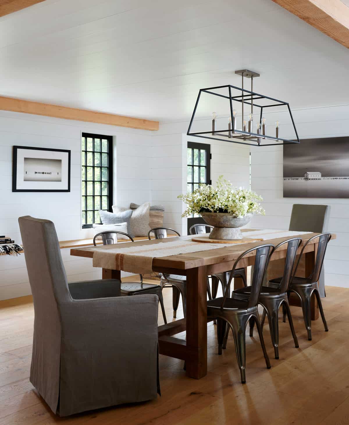 18-Dining-Room-AFTER. An inviting bench under the windows fills previously unused space, while creating storage and a seat with great views . Shiplap walls throughout the house contribute to the modern rustic feeling. Floors are engineered wide plank French Oak.