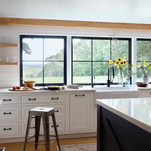 16-Kitchen-Sink-AFTER. New kitchen counters were extended to the sill of the window, allowing for taller windows and more of a connection to the outdoors, taking advantage of the spectacular views to the back of the house.
