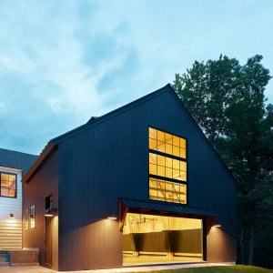 27-Fieldhouse-Barn-The new fieldhouse emulates a barn, allowing for a large structure with few windows, perfect for playing ball sports indoors. Attached to a basement level exercise room, kids and family regularly gather to play basketball, baseball, volleyball, and a variety of other athletic activities.