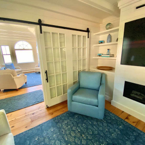 An old gas stove was replaced with a sleek, slim built-in that features a modern gas fireplace below, with TV above.