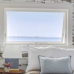 Owners Bedroom - The walls remain rustic to maintain the feeling of a ship's cabin. Though the  home remains small, it feels spacious and serene, and invites its occupants to absorb all the outside beauty that surrounds it.