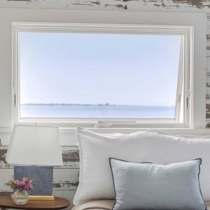 Owners Bedroom - The walls remain rustic to maintain the feeling of a ship's cabin. Though the  home remains small, it feels spacious and serene, and invites its occupants to absorb all the outside beauty that surrounds it.