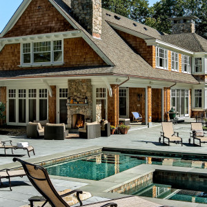 Back exterior details, view towards screen porch and exterior fireplace