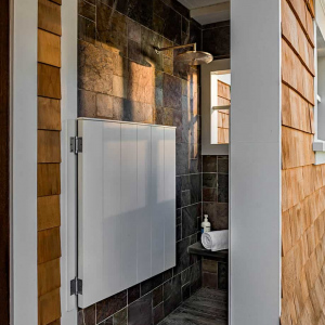Outdoor shower, located just outside the pool house, tucked under pergola.