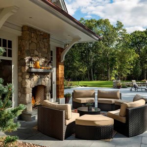 Sitting area faces  one side of double-sided fireplace.