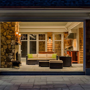 Three season room with phantom wall, built-in grill and two sided indoor/outdoor fireplace