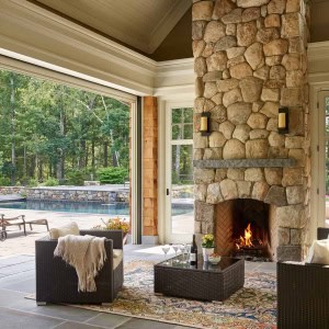 Three season room with double-sided fireplace and  Phantom Walls (choice of no walls, screens, or glass)