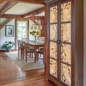 AFTER. The powder rm door was moved around the corner and replaced with a built-in custom walnut china cabinet with stained glass doors with interior backlighting.