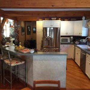 BEFORE A back hall was removed, enlarging the kitchen and opening it fully to LR