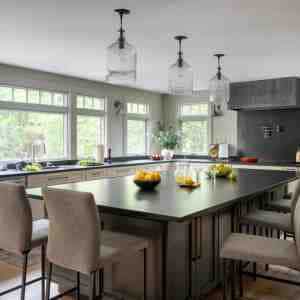 The motivation for this remodel was transforming the cramped kitchen into an expansive space to accommodate multiple chefs and guests, while improving light and views .  Colors and light fixtures are traditional,  while the appliances and cabinet hardware are modern.