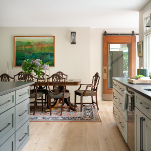 The dining area is now incorporated into the kitchen for a seamless entertaining experience.  Mudroom entrance is on the right, defined by the salvaged sliding glass door. 